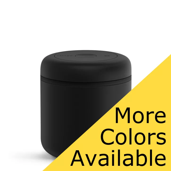 The DISCONTINUED Fellow Atmos Vacuum Canister 0.7 L in stainless steel is displayed on a white background, featuring a button on the lid and a yellow diagonal banner reading More Colors Available in bold black text. © 2025 1st-line.com